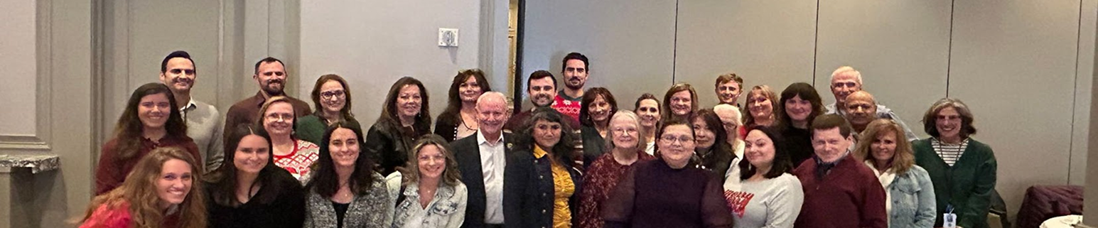 Group portrait of 31 Treasury team members standing together in the office, smiling and facing the camera. The photo was taken in a casual, collaborative workspace, reflecting a friendly and professional team environment.
