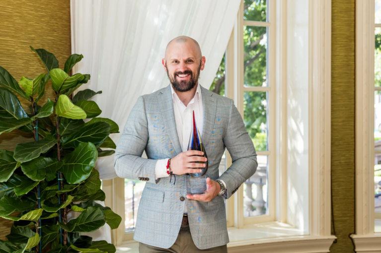 Hunter Railey, Director of the Colorado SecureSavings Program accepting an award from Pensions and Investements